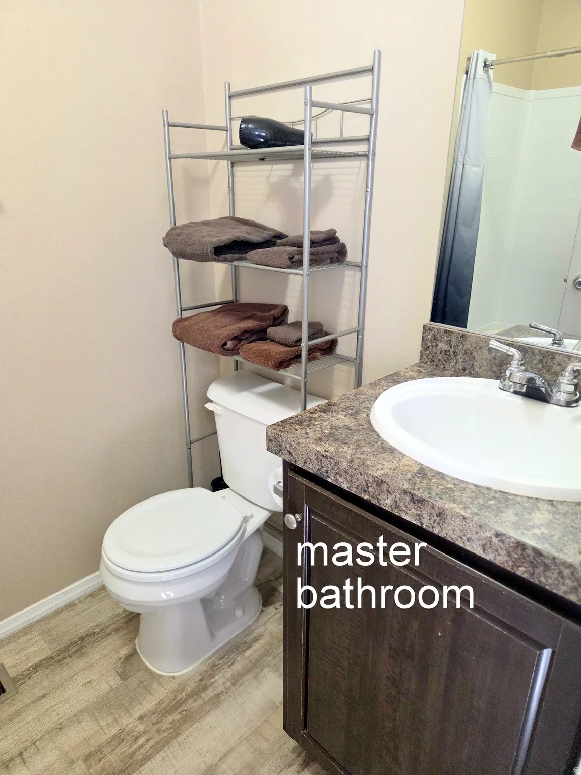 Full bath featuring vanity, a shower with curtain, and light wood finished floors