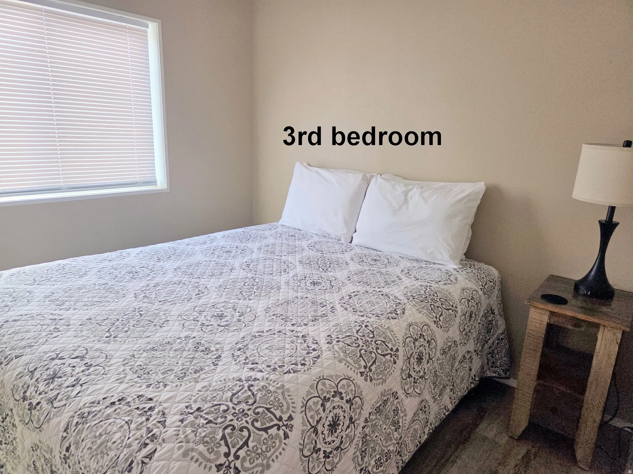 3-Bedroom with dark wood finished floors. All bedrooms have views out their windows.