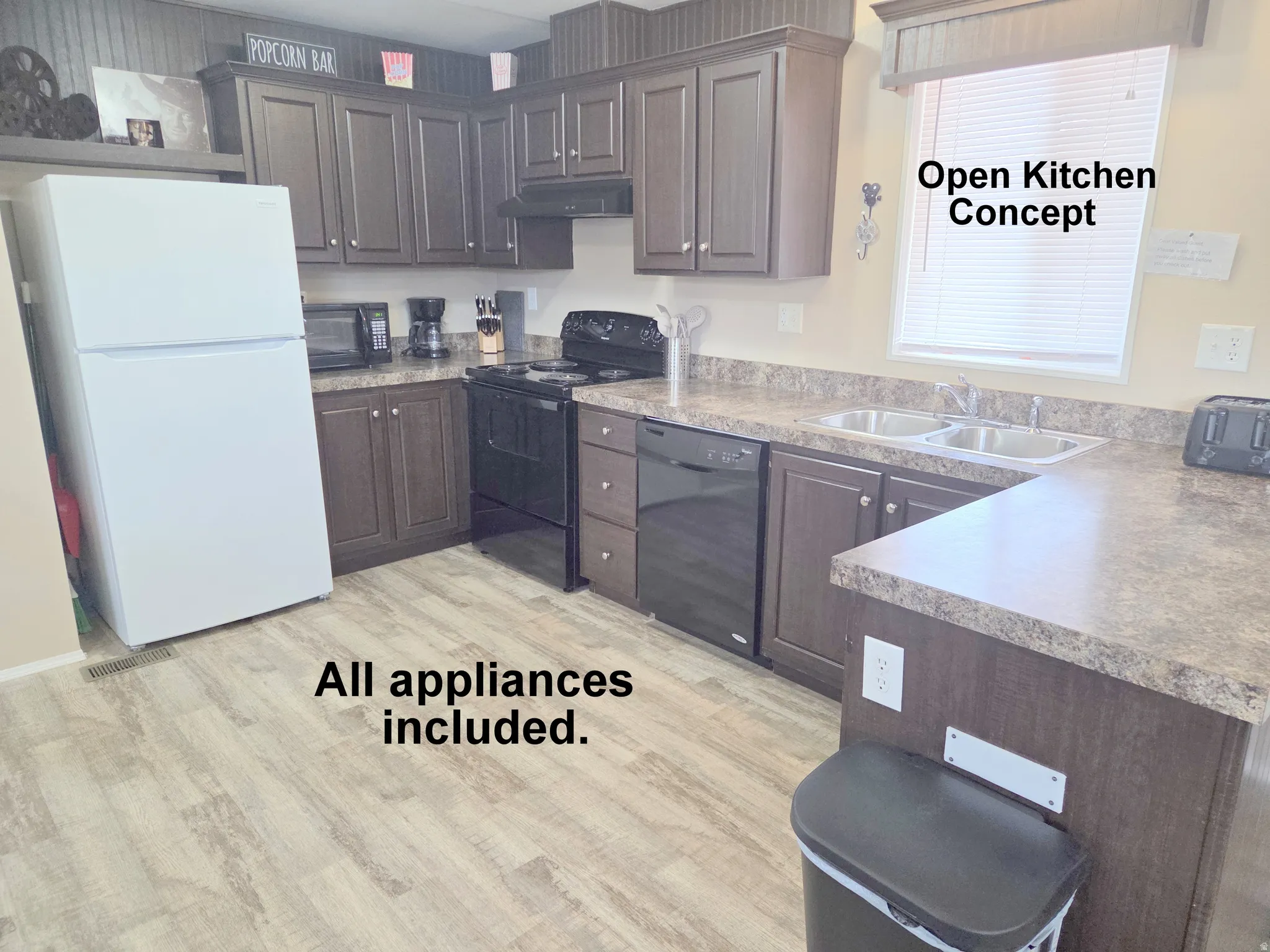 Kitchen featuring dark wood-finish cabinetry, laminate countertops, and wood-finish flooring