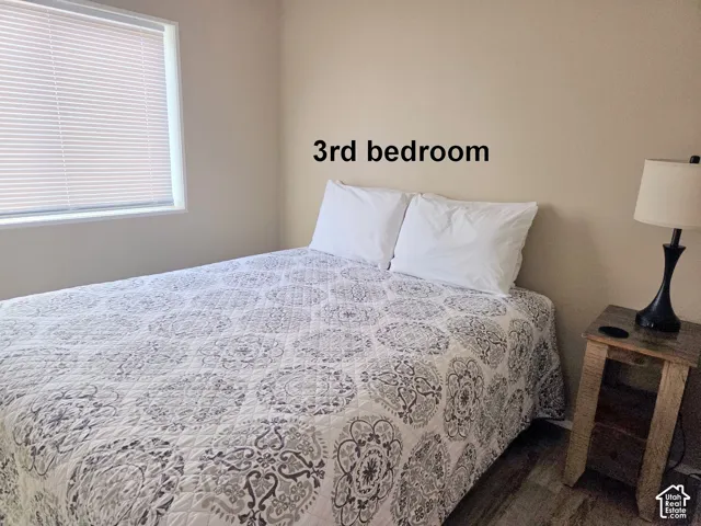 3-Bedroom with dark wood finished floors. All bedrooms have views out their windows.