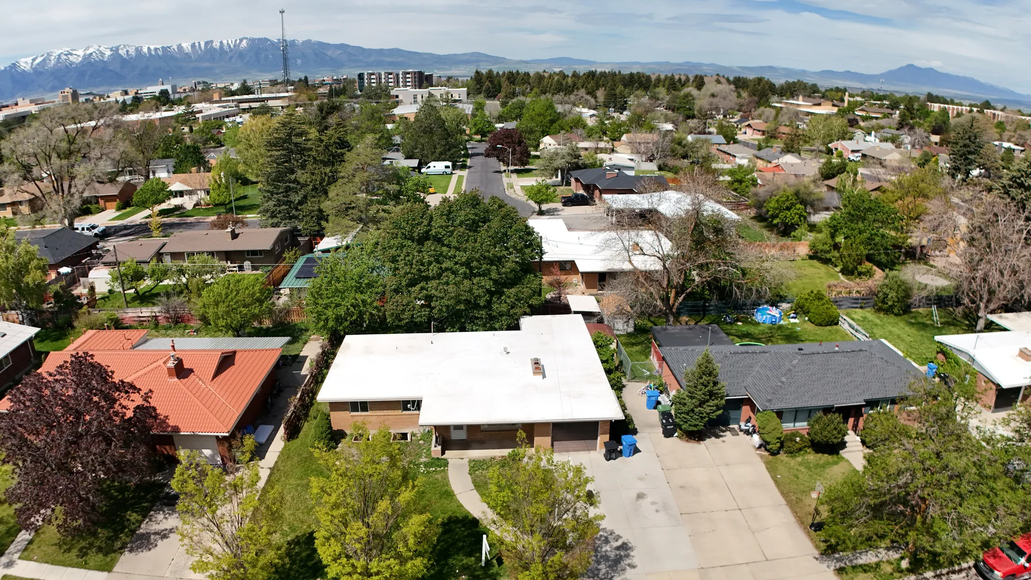 Aerial view showcasing a residential neighborhood with varied architectural styles and mature landscaping