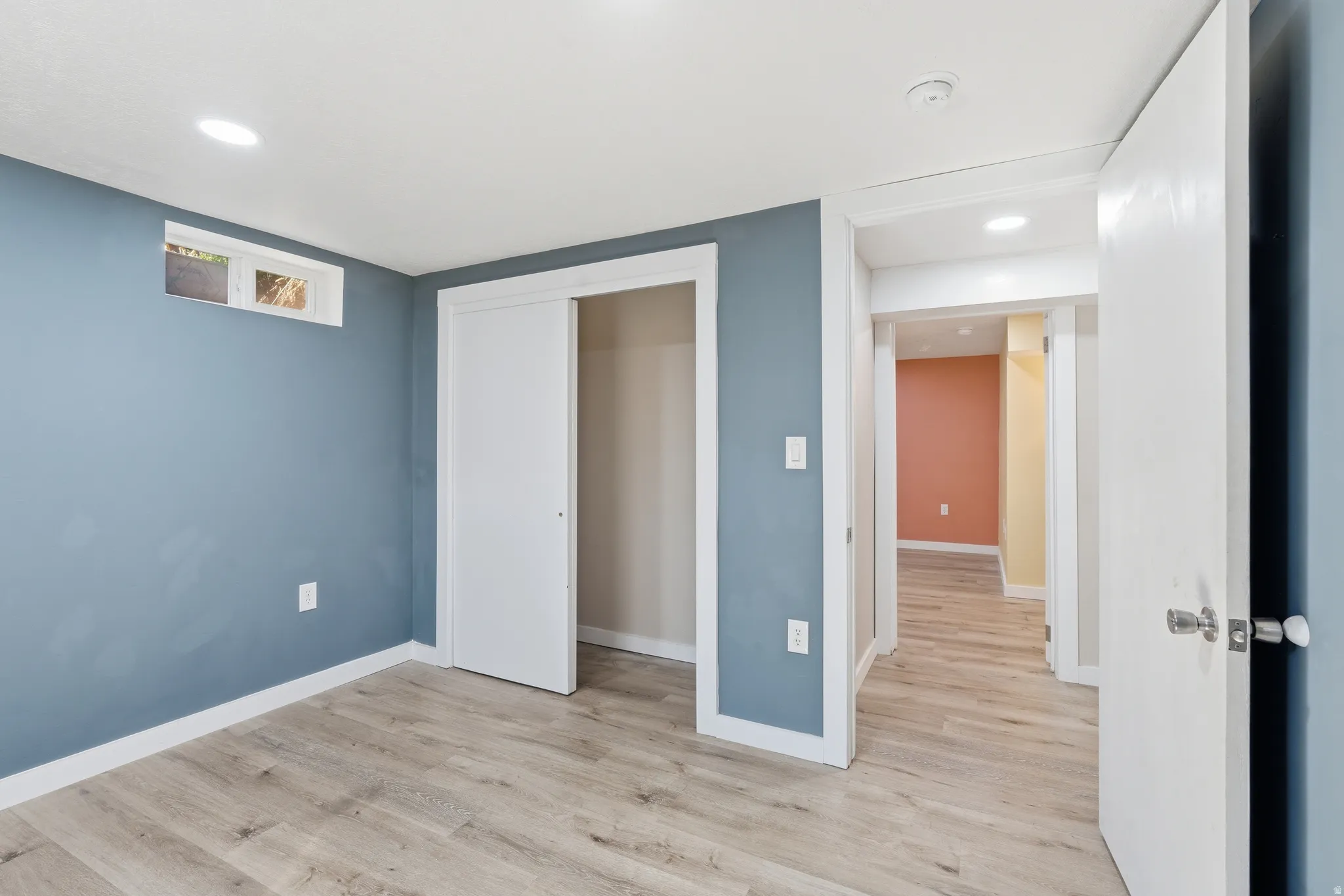 Unfurnished bedroom with light wood-style flooring, a closet, and recessed lighting