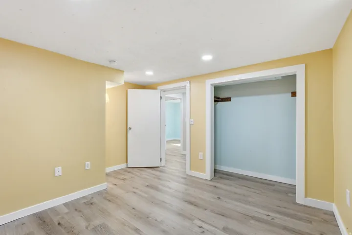 Unfurnished bedroom with light wood-style floors, recessed lighting, and a closet
