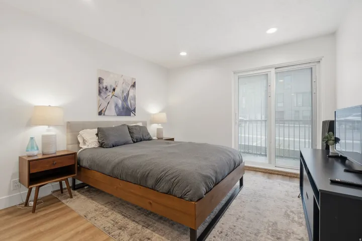 Bedroom with light wood-type flooring, access to exterior, and recessed lighting