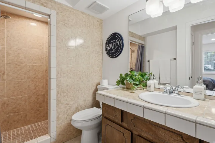 Bathroom with vanity, a tile shower, and ensuite bathroom