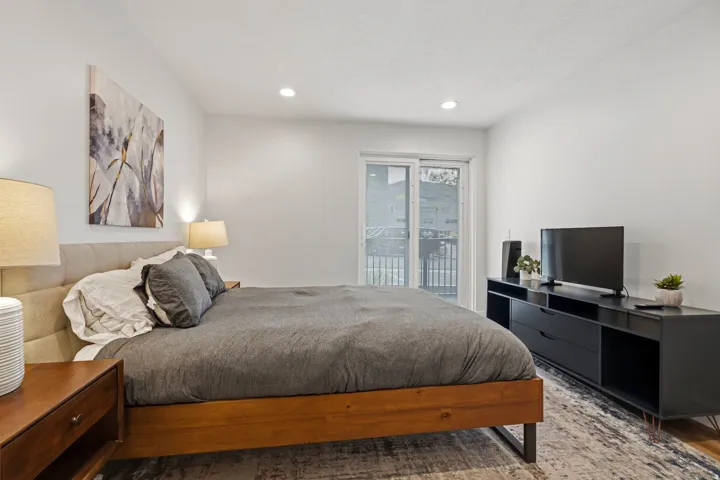 Bedroom featuring wood finished floors, access to outside, and recessed lighting