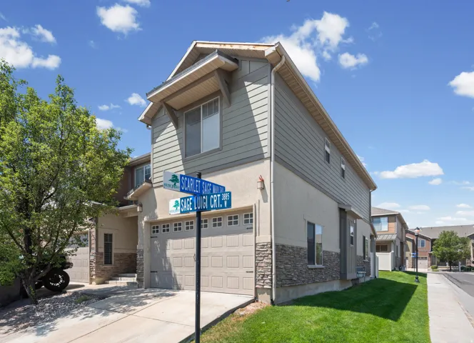 Contemporary two-story residence with a two-car garage, featuring a combination of stucco and horizontal siding