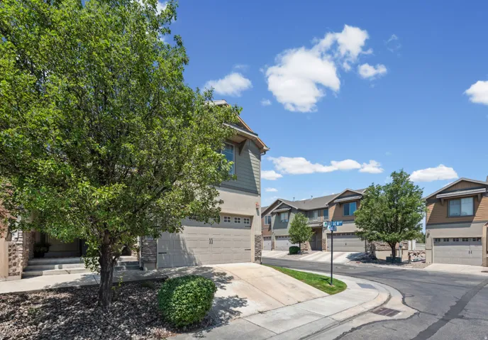 Exterior featuring a two-story design with a garage, stucco siding, and stone accents