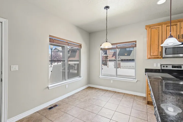 Tile flooring in a breakfast nook with two large windows