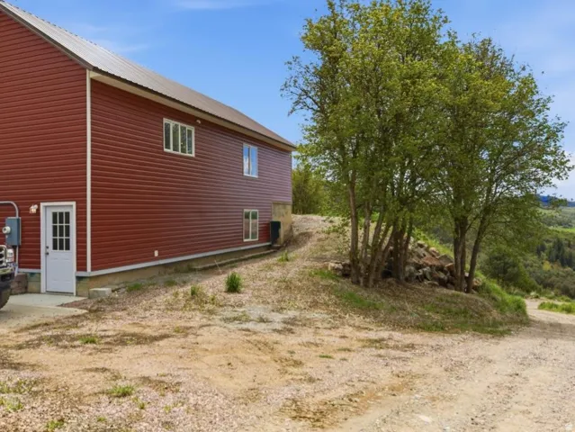 View of side of property featuring a metal roof