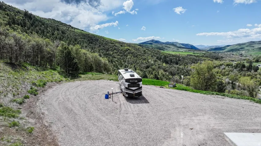 Bird's eye view of mountains and a forest with rv hookups ready