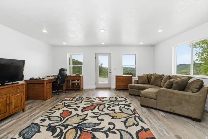 Living area with a desk and light wood-type flooring
