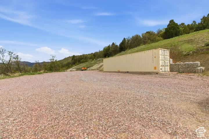 View of yard- storage shed-graveled area