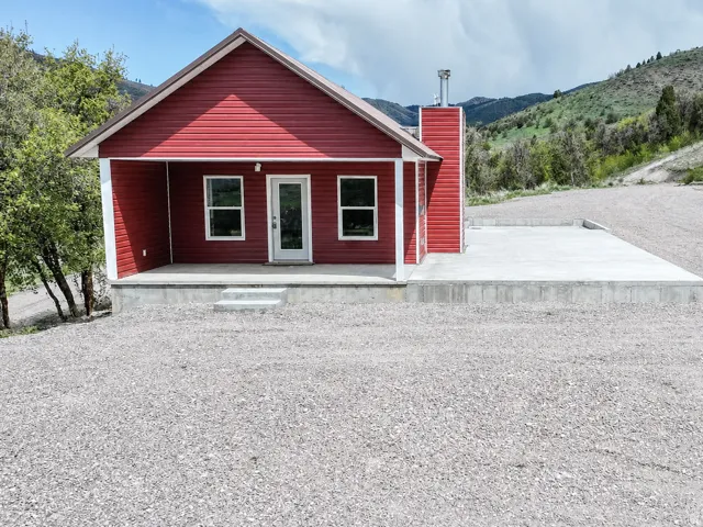 View of front of property with covered porch and a chimney