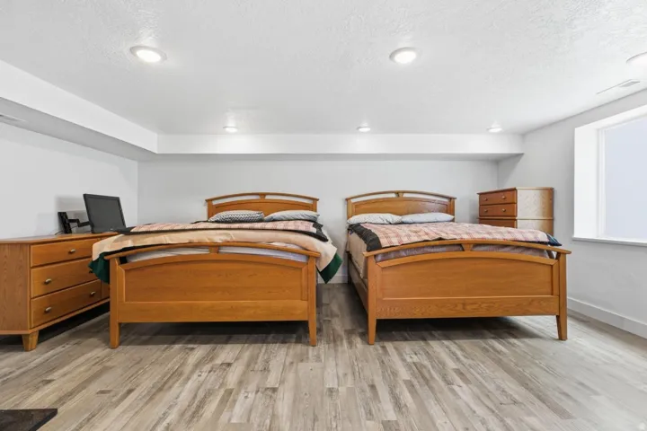 Bedroom with light wood-style flooring and a textured ceiling