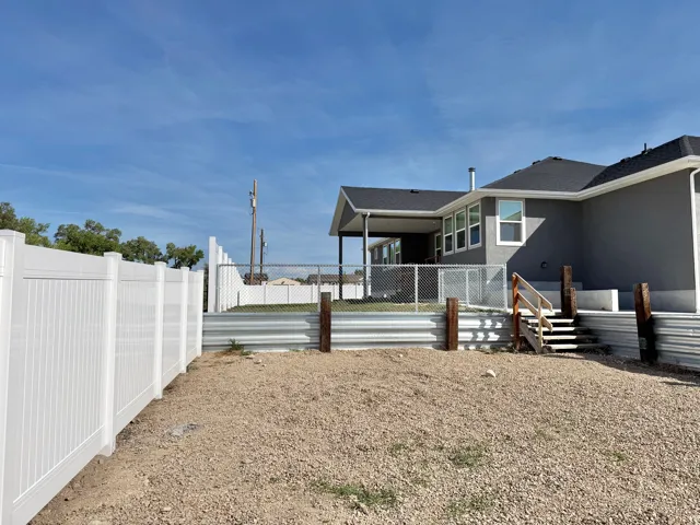 White vinyl privacy fencing and chain link fencing
