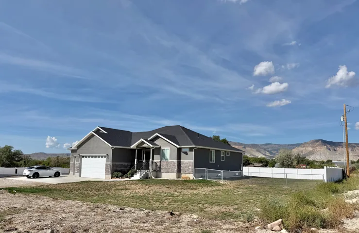 Ranch-style exterior with gray siding and stone accents