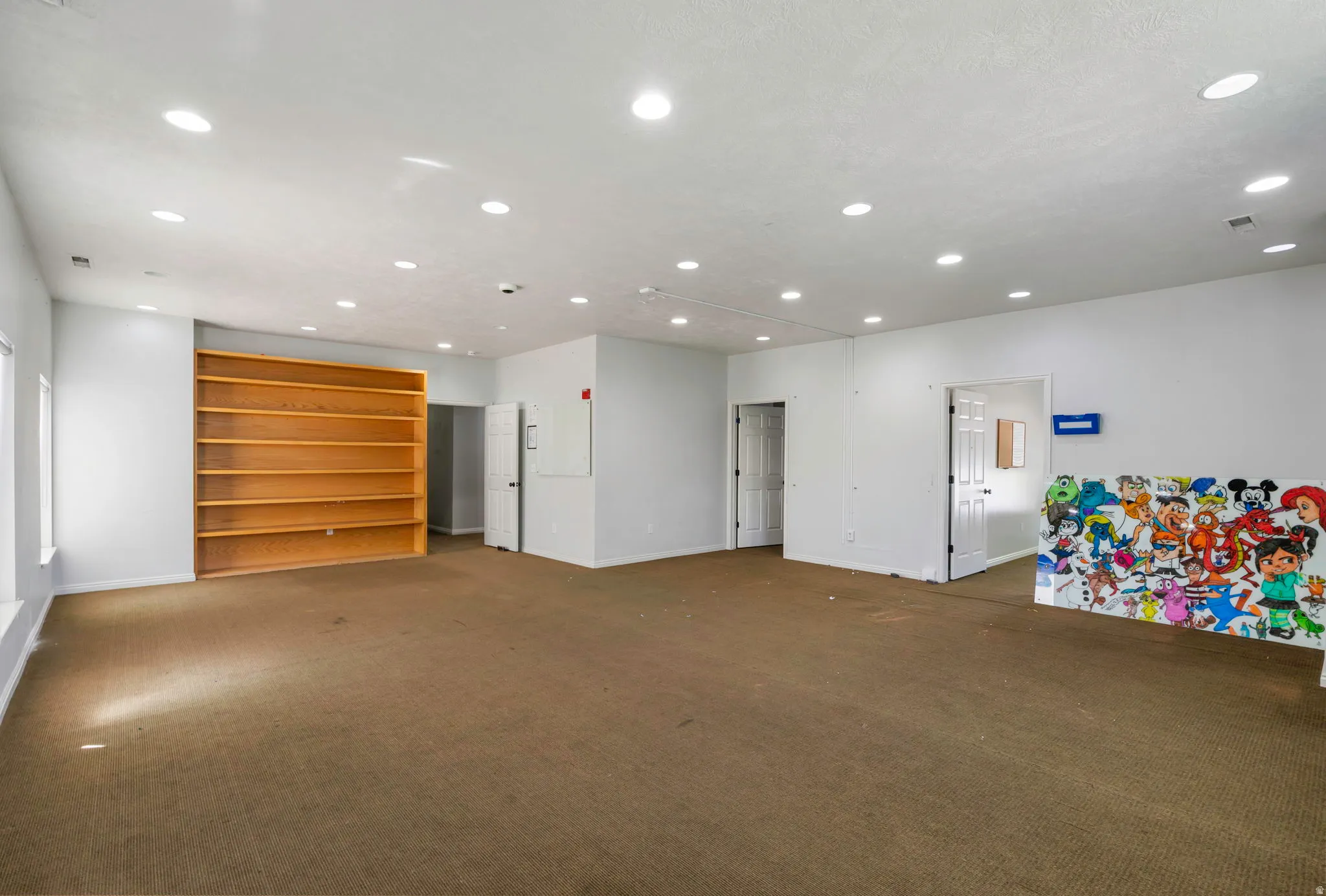 Carpeted spare room featuring recessed lighting and baseboards