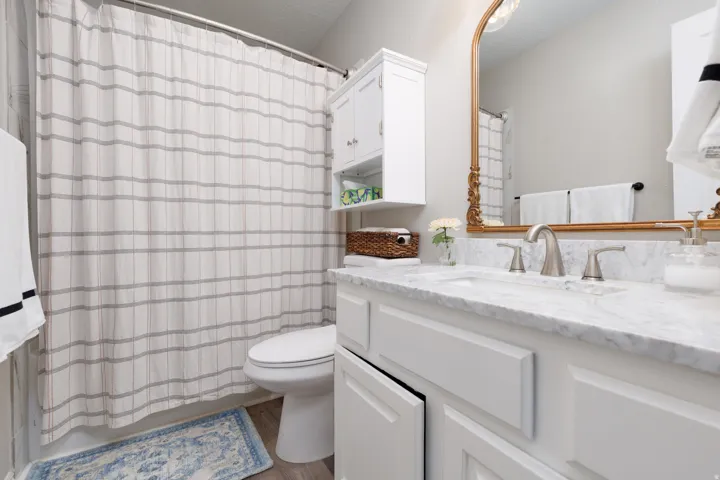 Bathroom featuring vanity, a textured ceiling, and light wood-style flooring