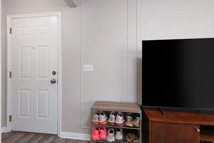 Entry featuring dark wood finished floors and baseboards