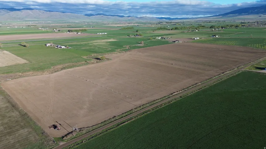 Overview of rural landscape featuring farmland and mountains