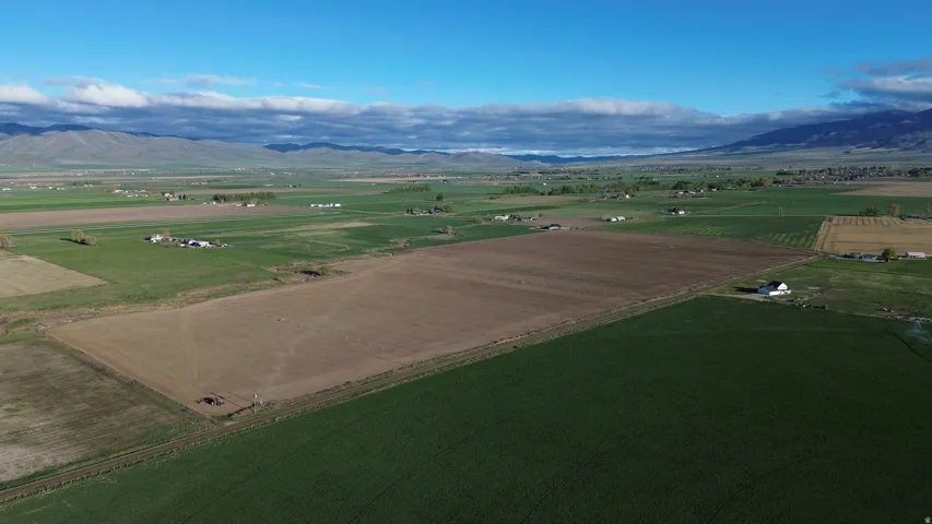 View of rural area featuring large plots for crops and a mountain backdrop