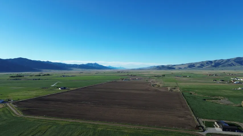 View of mountain background with rural landscape and rows of crops