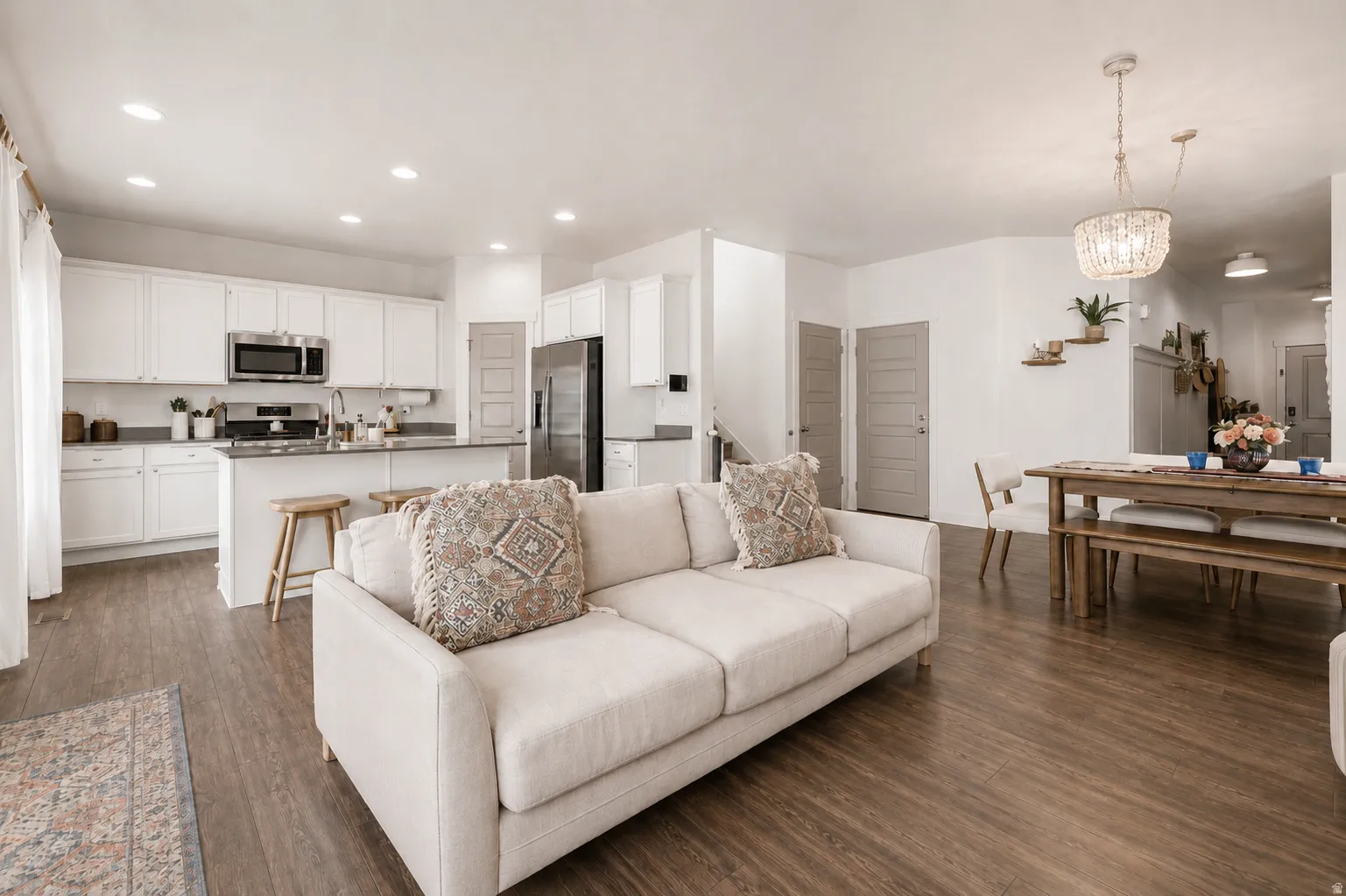 Open-concept living space featuring wood-finish flooring throughout