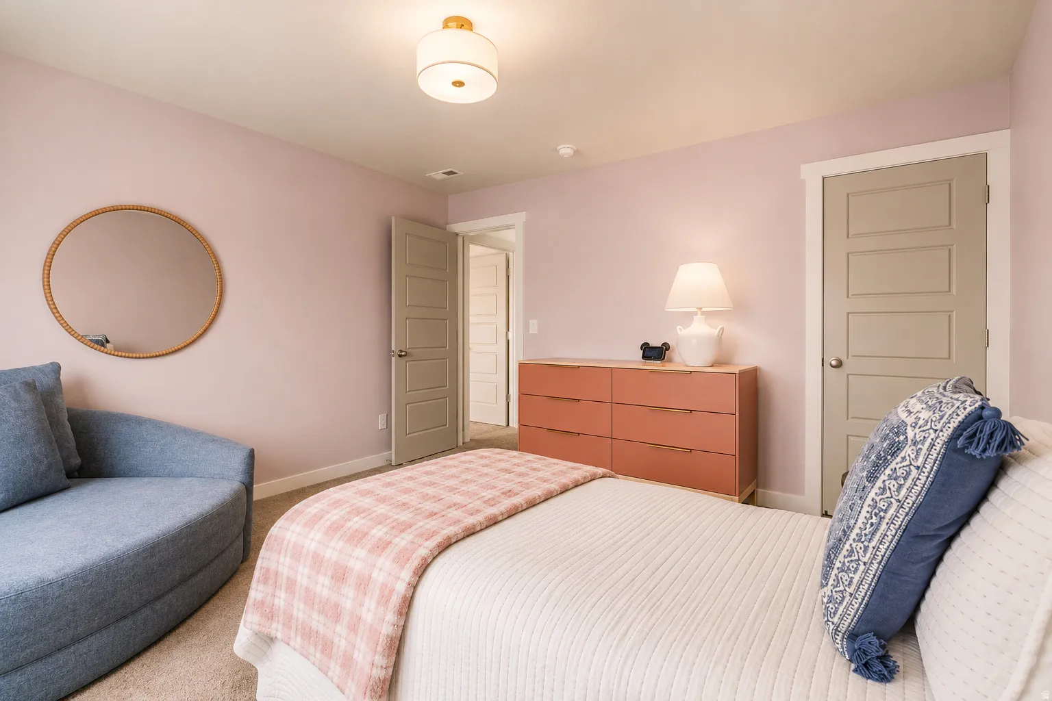 Carpeted room with light pink walls and white trim