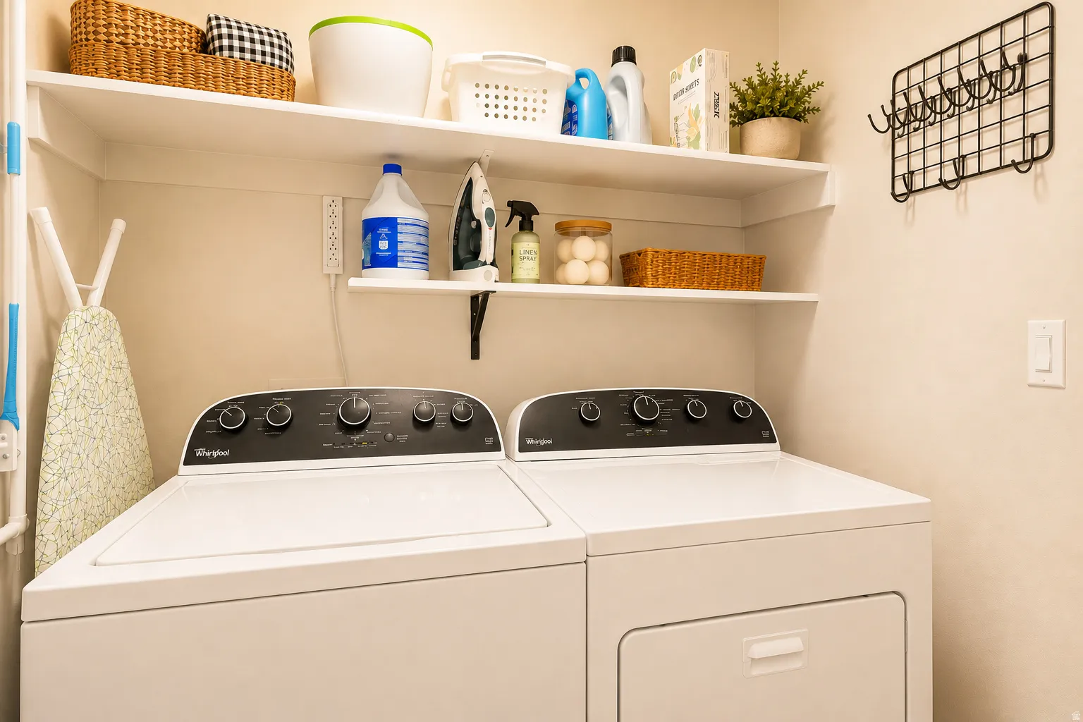 Dedicated laundry area featuring a top-load washing machine and front-load dryer