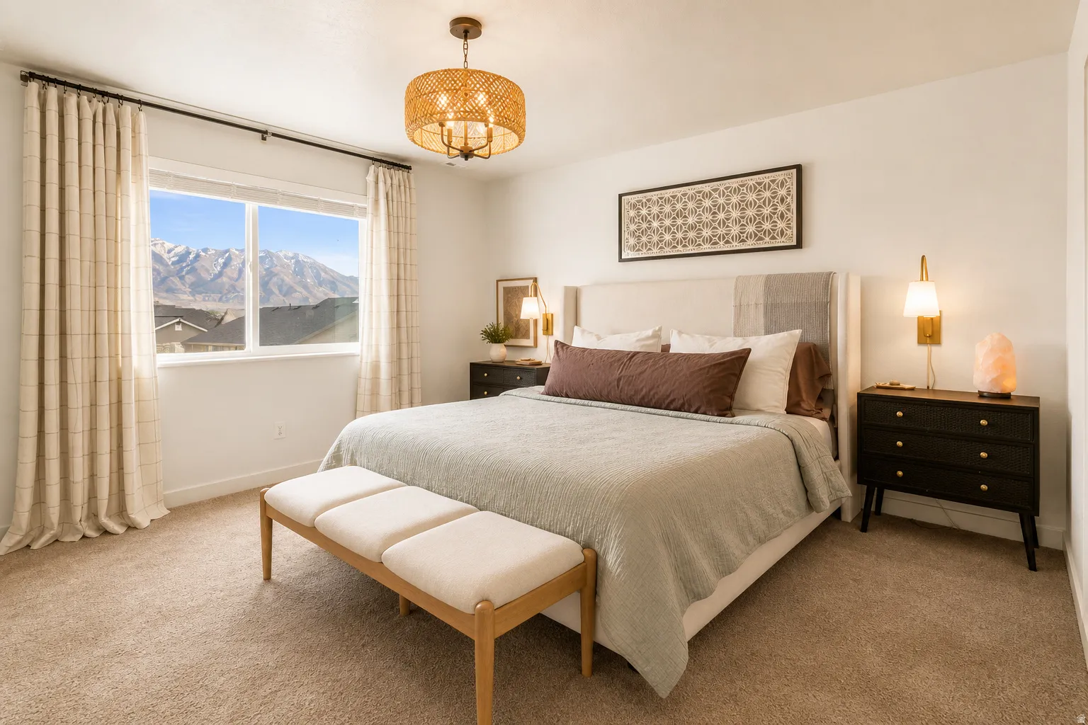 Bedroom featuring a large window with mountain scenery, plush carpet flooring, and a contemporary woven pendant light fixture