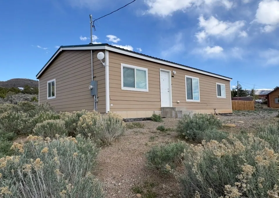 Rear view of property featuring a metal roof