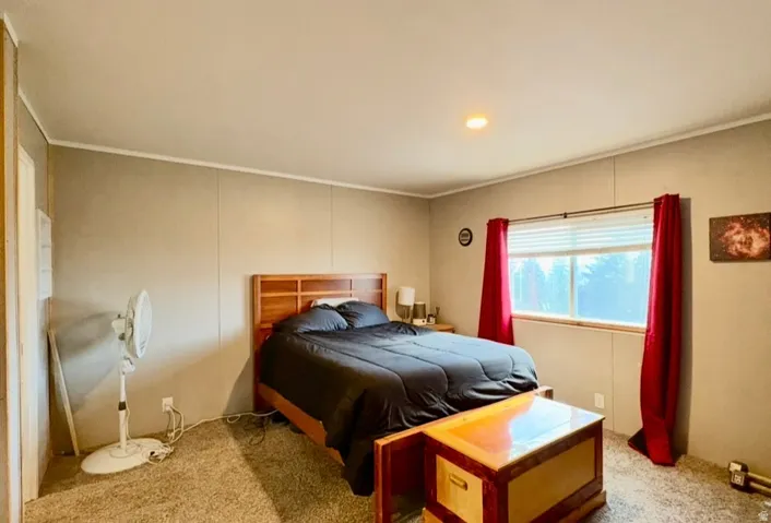Bedroom featuring light carpet and ornamental molding