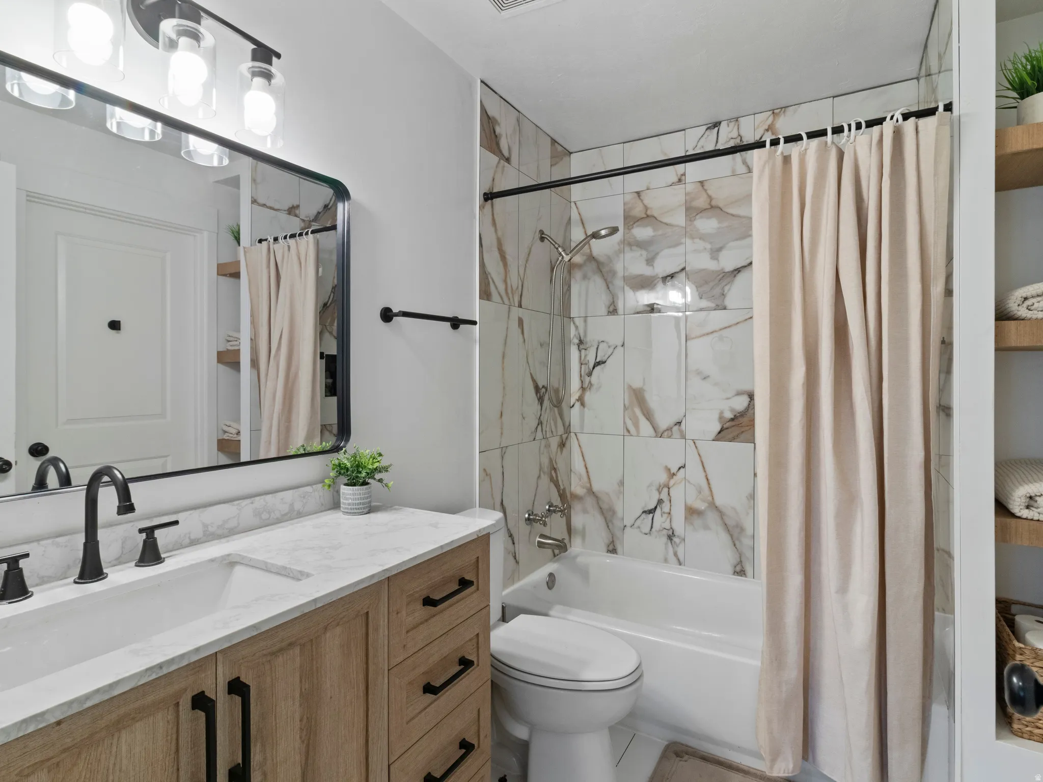 Bathroom featuring vanity and shower / tub combo