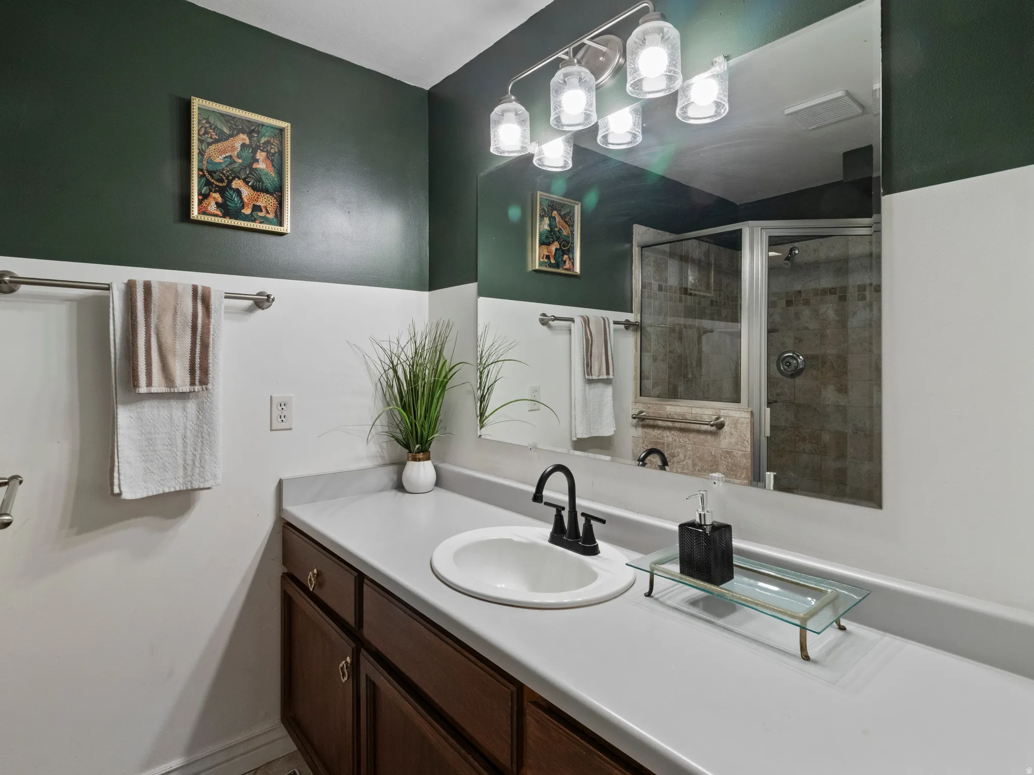 Full bathroom featuring vanity and a stall shower
