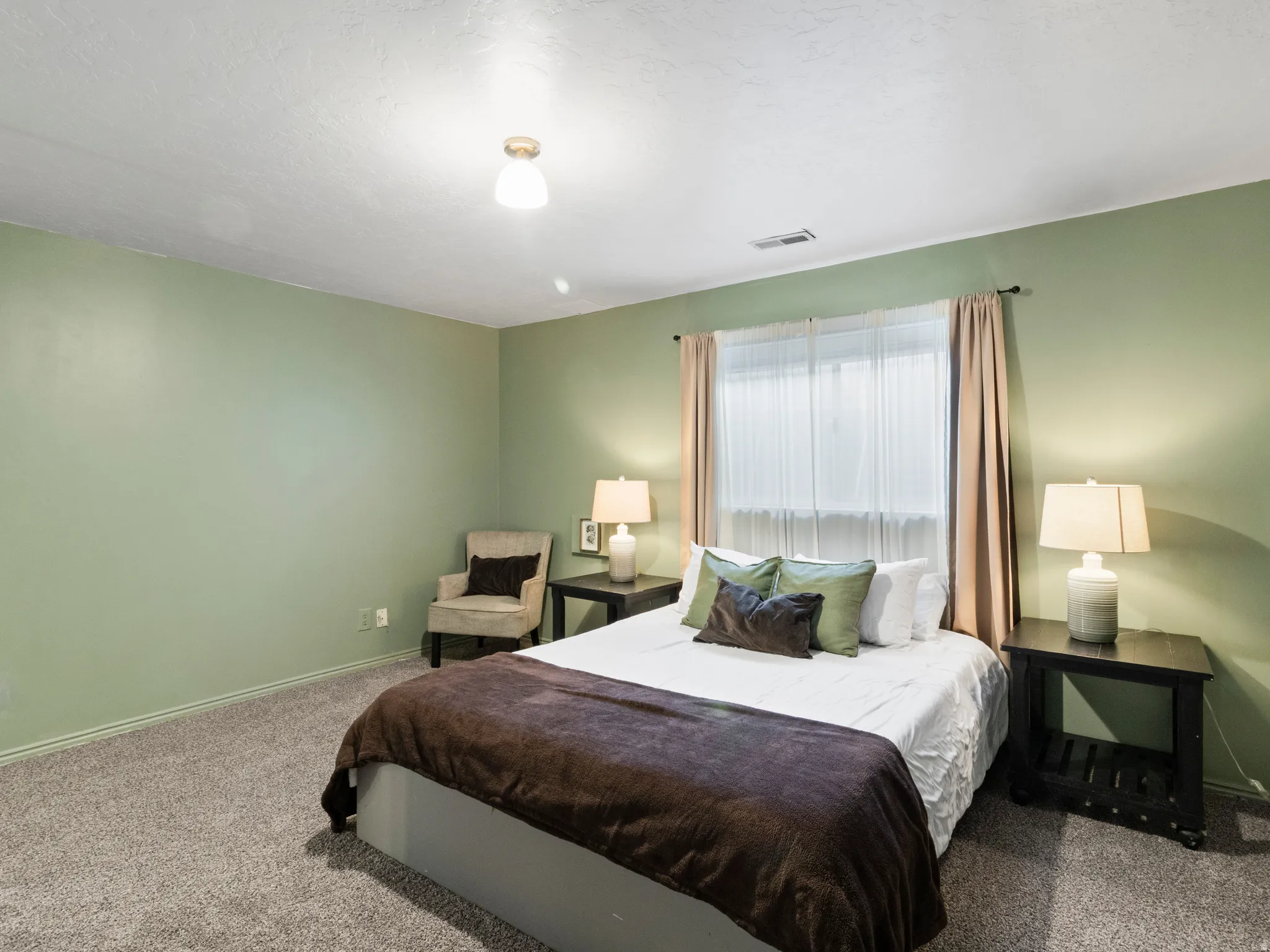 Carpeted bedroom featuring baseboards