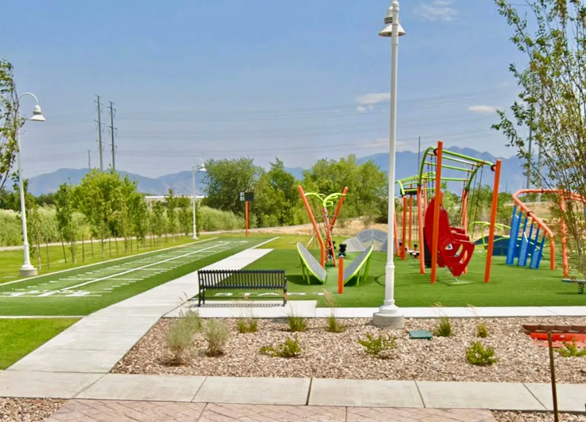 View of jungle gym with a lawn