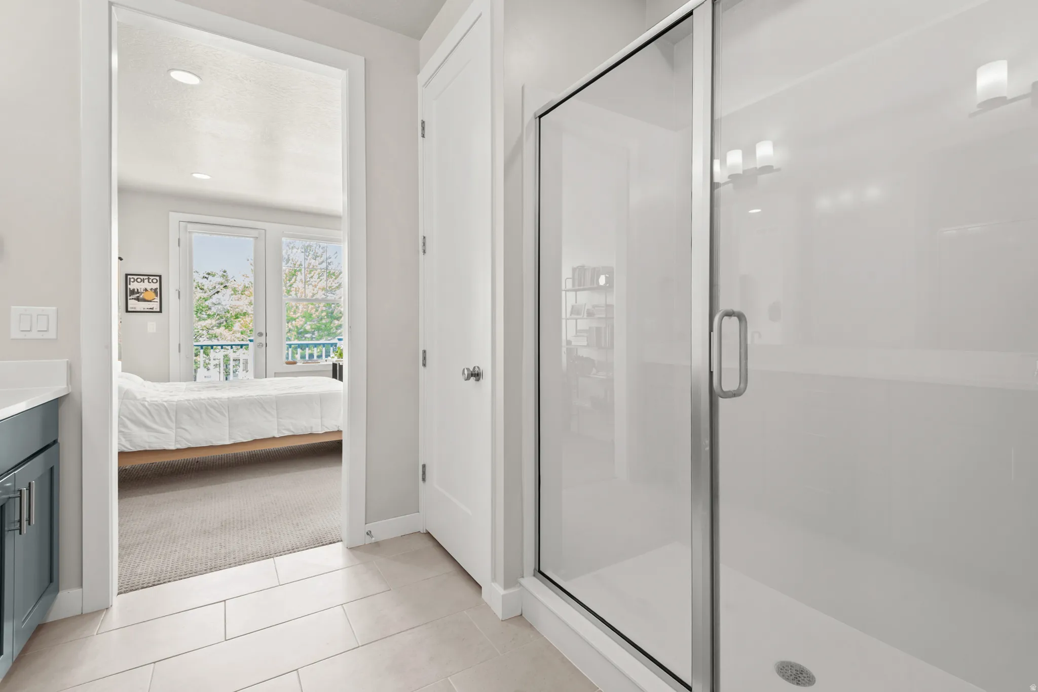 Glass-enclosed shower with contemporary light fixtures