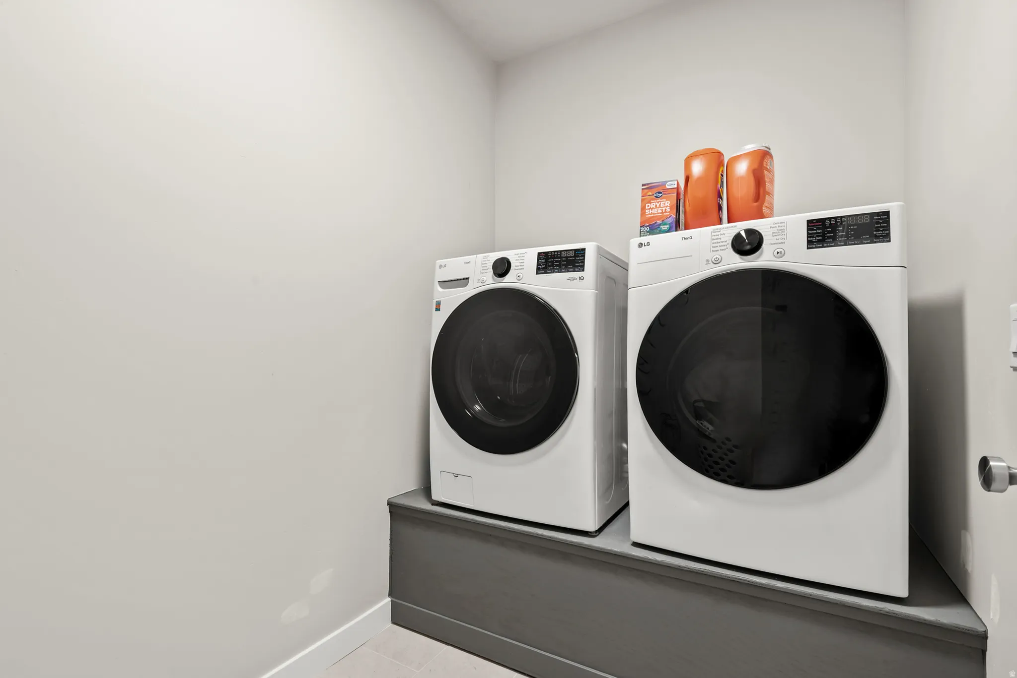 Dedicated laundry area featuring front-loading washer and dryer units