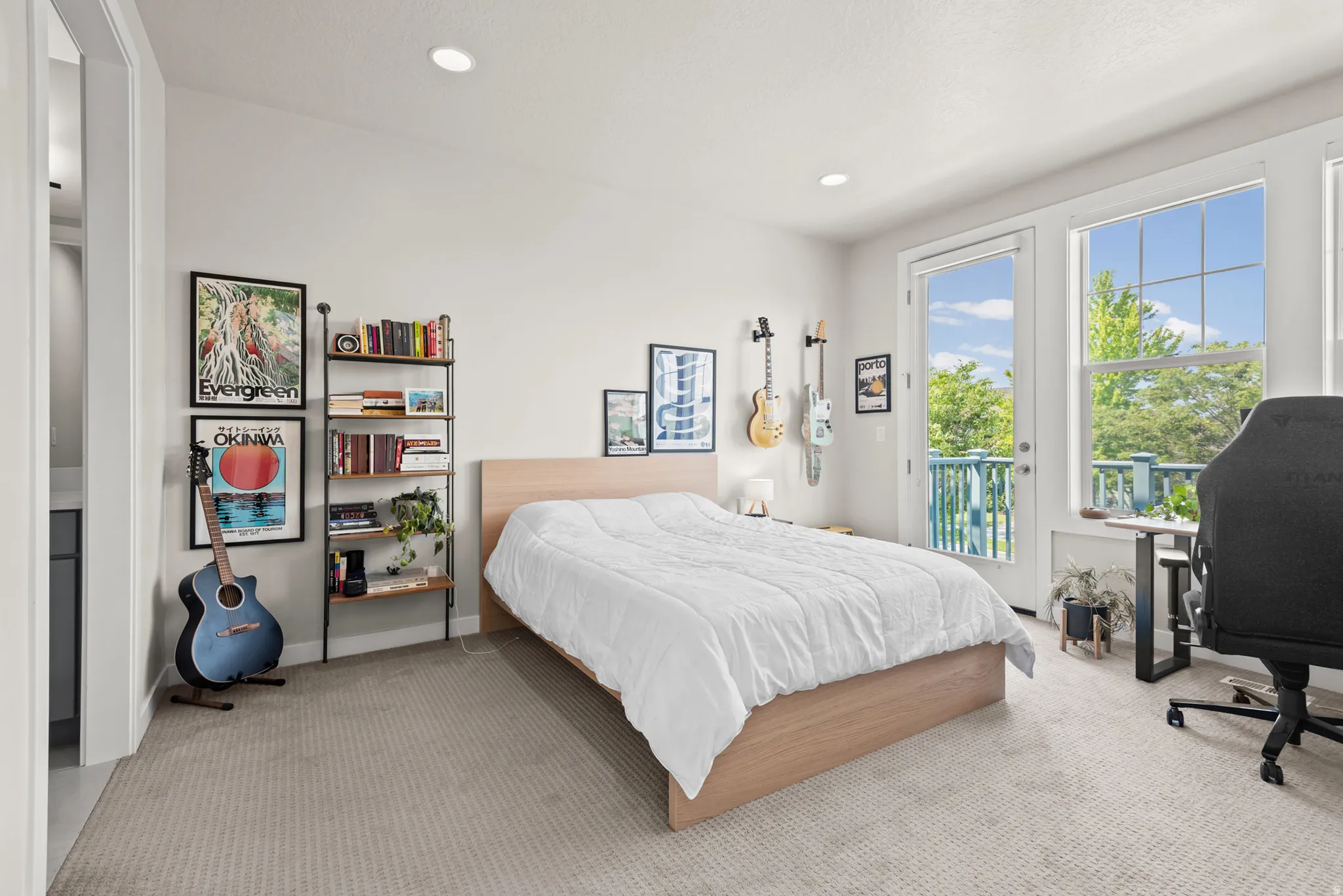 Bright room featuring light-toned carpet flooring, recessed lighting, and white walls