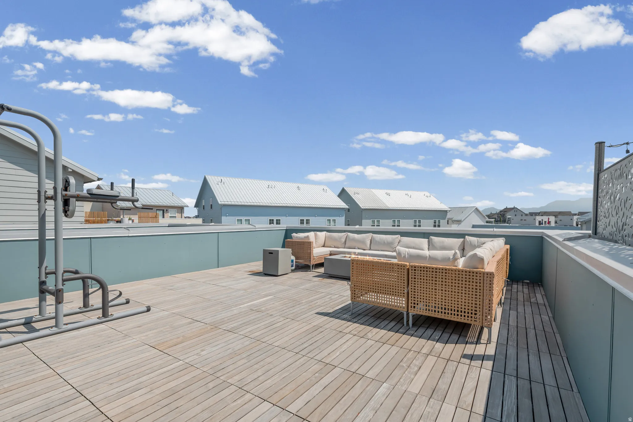 Rooftop deck featuring plank flooring and a low privacy wall