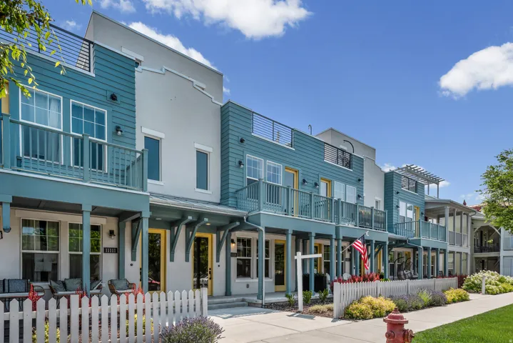 Contemporary townhome facades featuring varying blue siding and light stucco finishes
