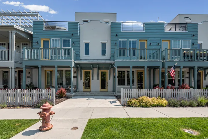 Contemporary multi-story facade featuring distinct blue siding and light grey stucco accents