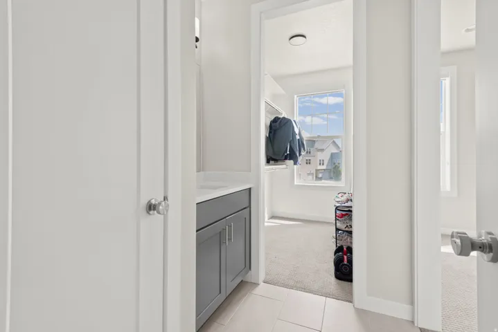 Hallway with a built-in vanity featuring a gray cabinet and white countertop