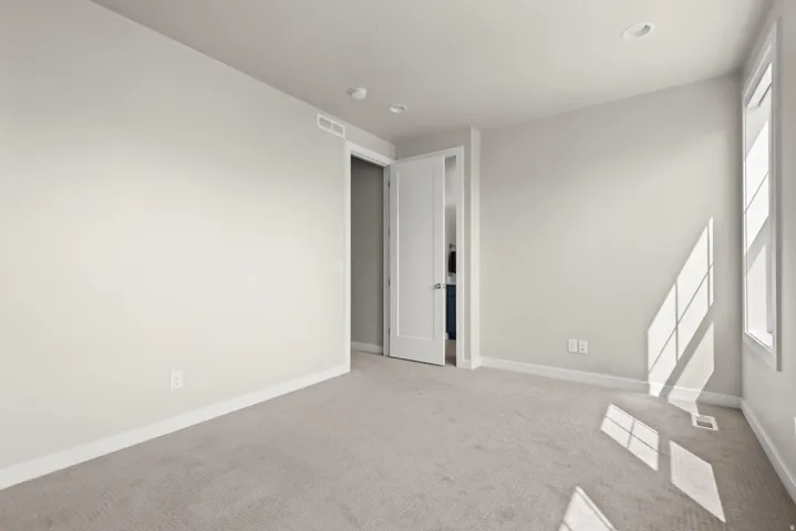 Light-filled interior featuring neutral wall tones and plush carpeting