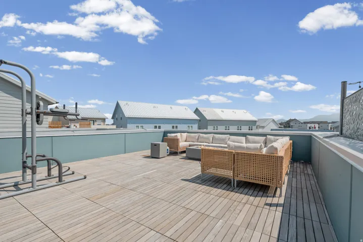 Rooftop deck featuring plank flooring and a low privacy wall