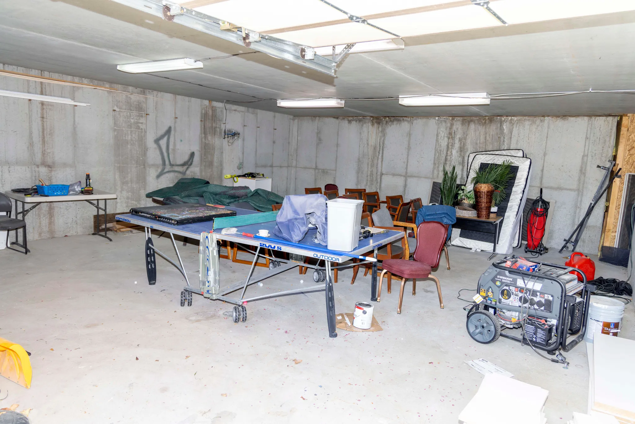 Basement storage area with large garage style door to back yard