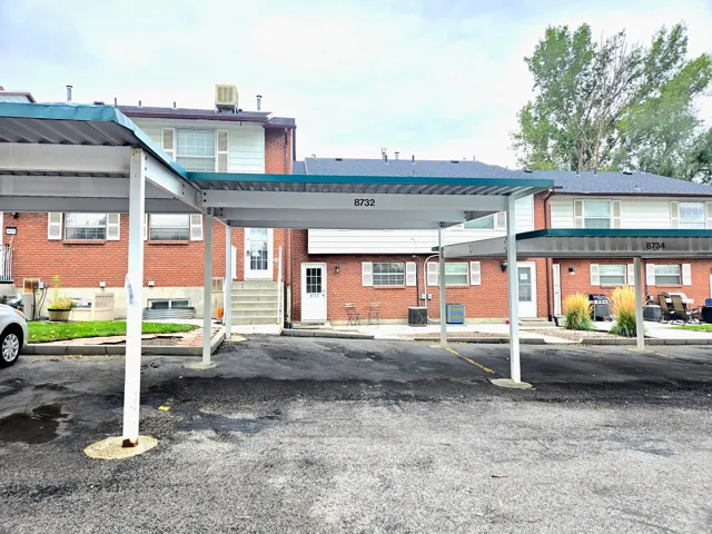 View of property with covered parking