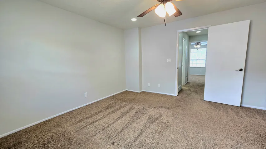 Unfurnished bedroom with carpet, recessed lighting, and a ceiling fan