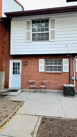Back of property featuring brick siding